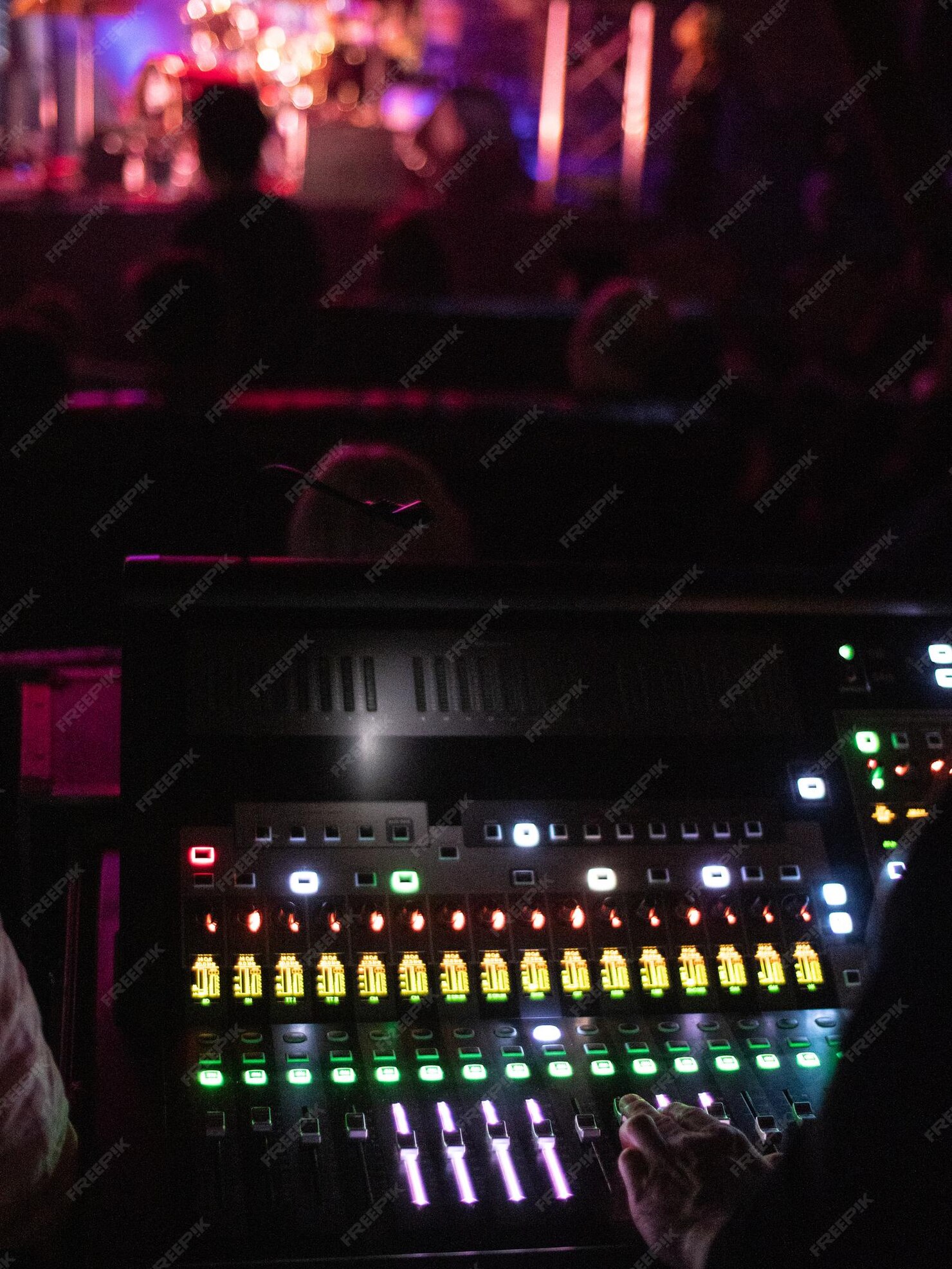 cropped-hand-person-using-illuminated-sound-mixer_1048944-373810